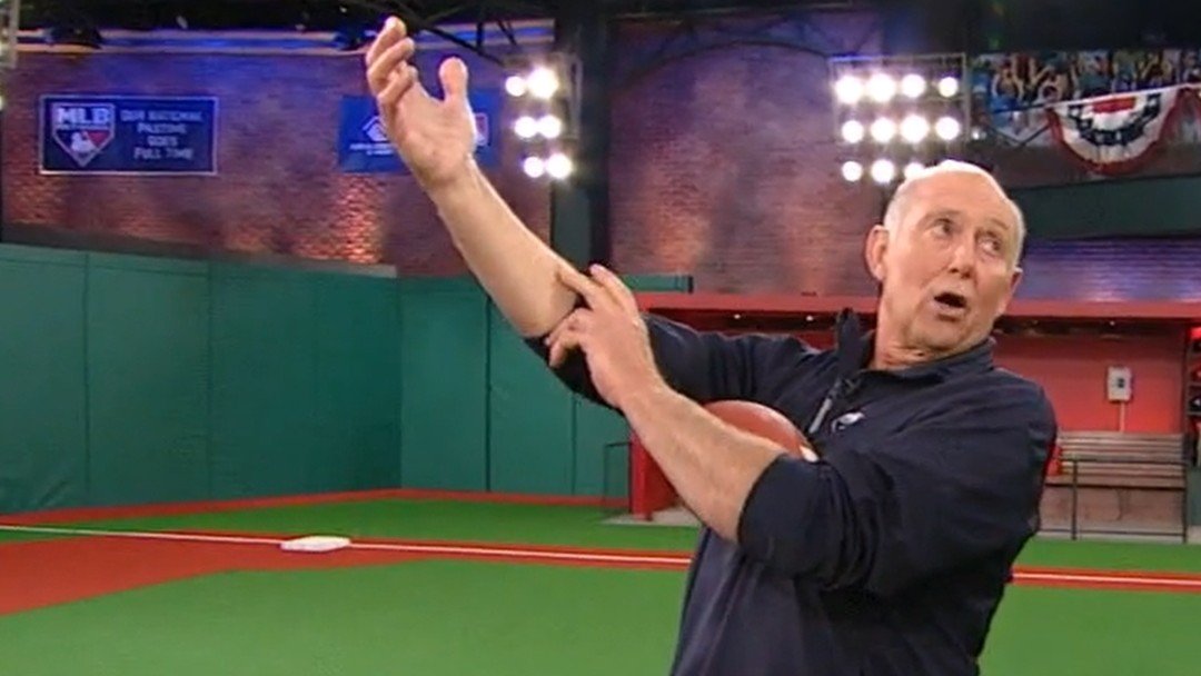 Dr. Mike Marshall mid-demonstration of pronation versus supination during 2009 MLB Network segment, illustrating elbow protection through biomechanical motion.