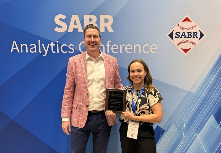Scott Bush, CEO of the Society for American Baseball Research (SABR), and Kristen M. Stewart at the 2026 SABR Analytics Conference, where Stewart received the Dr. Mike Marshall Baseball Pitching Biomechanics Research Award.